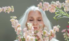 Woman With White Hair Surrounded by White and Pink Flowers